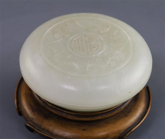 A Chinese white jade circular seal paste box, 18th/19th century, D. 6.5cm, wood stand